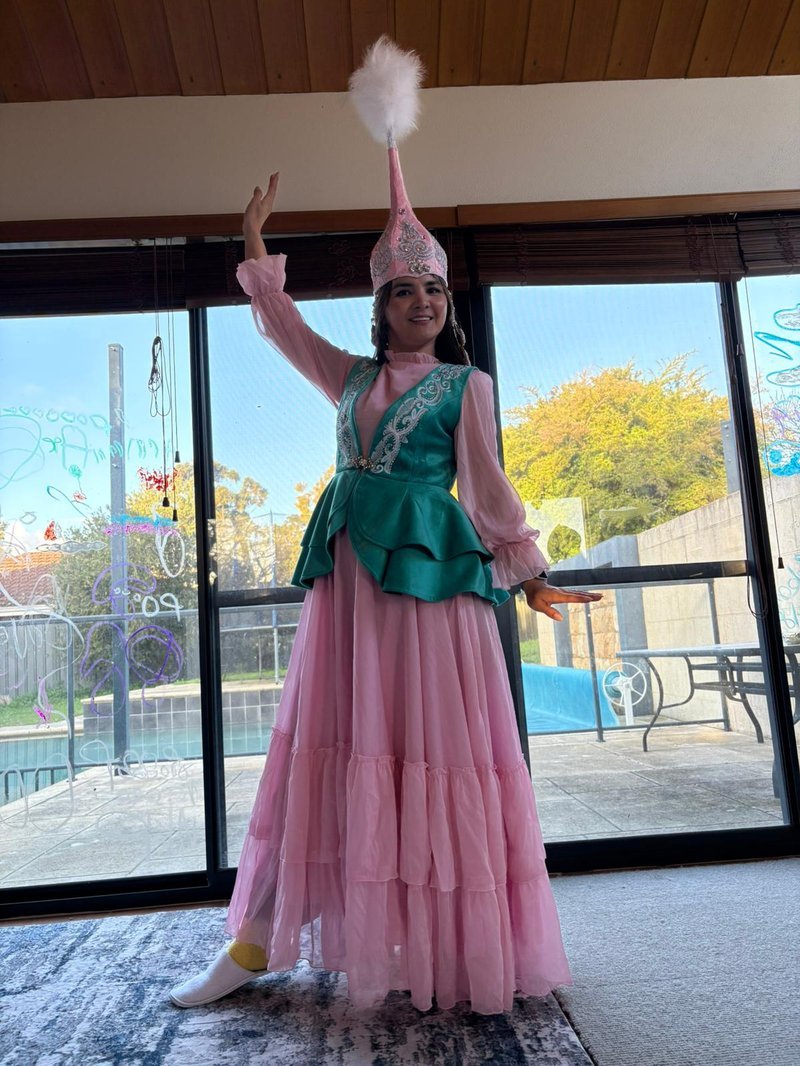 Tlekshi of Queen Bee Nails in traditional Kazakh dress