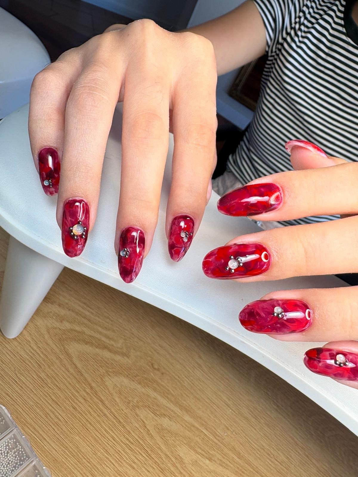 Russian manicure hard gel and colour in long red marble with nail extensions and crystal accents by Queen Bee Nails in Rockingham WA